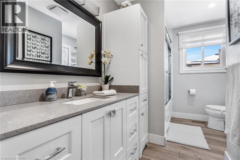 Bathroom with vanity, light wood-style floors, and bathing tub / shower combination - 136 Limpert Avenue, Cambridge, ON - Indoor Photo Showing Bathroom