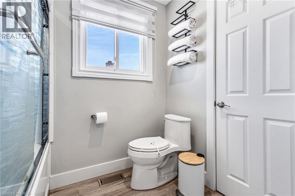 Full bath with wood finished floors and shower / bath combo with shower curtain - 136 Limpert Avenue, Cambridge, ON - Indoor Photo Showing Bathroom