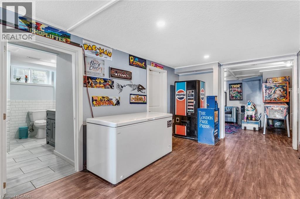 Laundry room with dark wood-type flooring, a textured ceiling, and recessed lighting - 136 Limpert Avenue, Cambridge, ON - Indoor