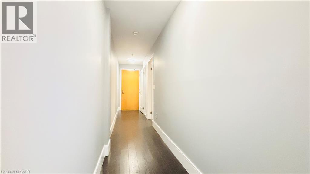 Hallway with baseboards and dark wood-style flooring - 155 St. Leger Unit# 107, Kitchener, ON - Indoor Photo Showing Other Room