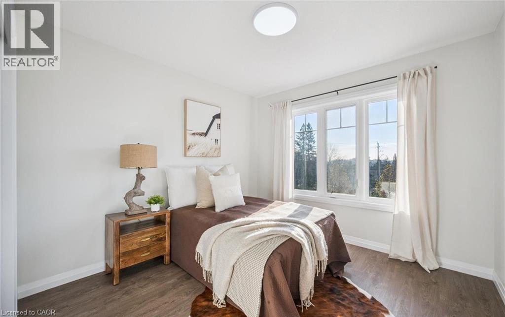 Bedroom with dark wood-style floors and baseboards - 24 Morrison Road Unit# D9, Kitchener, ON - Indoor Photo Showing Bedroom