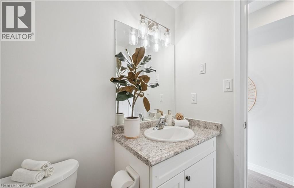 Bathroom with vanity and light wood-style flooring - 24 Morrison Road Unit# D9, Kitchener, ON - Indoor Photo Showing Bathroom