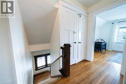 Hall with an upstairs landing and hardwood / wood-style floors -