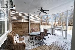 Snow covered deck featuring a ceiling fan and outdoor dining area -