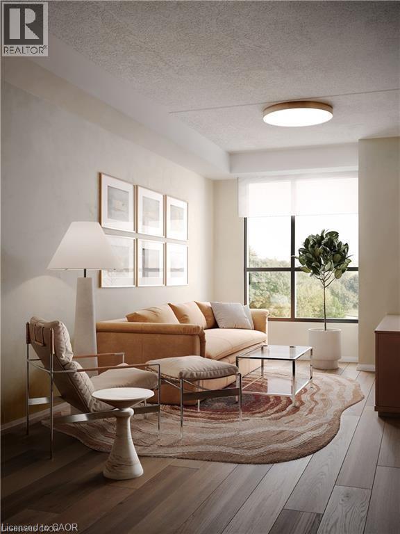 Living room featuring a textured ceiling and wood finished floors - 580 Coldstream Drive Unit# 302, Waterloo, ON - Indoor Photo Showing Living Room