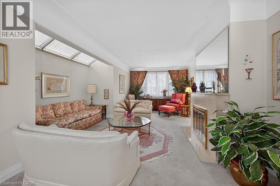 Living room featuring a fireplace and light carpet - 9 Daleview Court, Hamilton, ON - Indoor