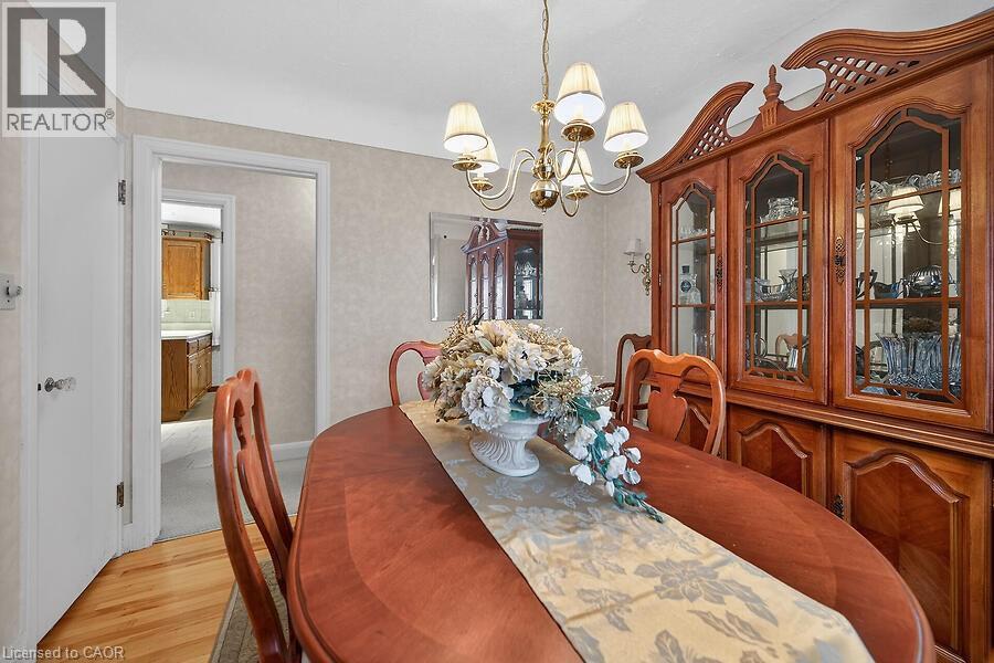 Dining space with suspended lighting and light wood finished floors - 9 Daleview Court, Hamilton, ON - Indoor Photo Showing Dining Room
