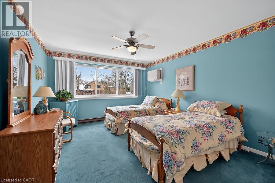 Bedroom with carpet floors, ceiling fan, and a baseboard heating unit - 9 Daleview Court, Hamilton, ON - Indoor Photo Showing Bedroom