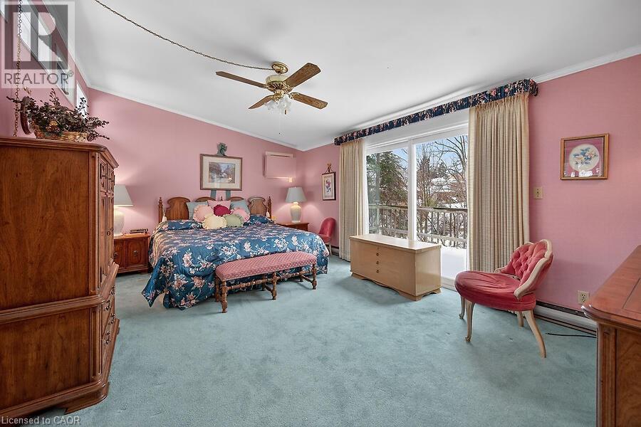 Bedroom featuring light colored carpet, ceiling fan, a baseboard radiator, access to exterior, and vaulted ceiling - 9 Daleview Court, Hamilton, ON - Indoor Photo Showing Bedroom