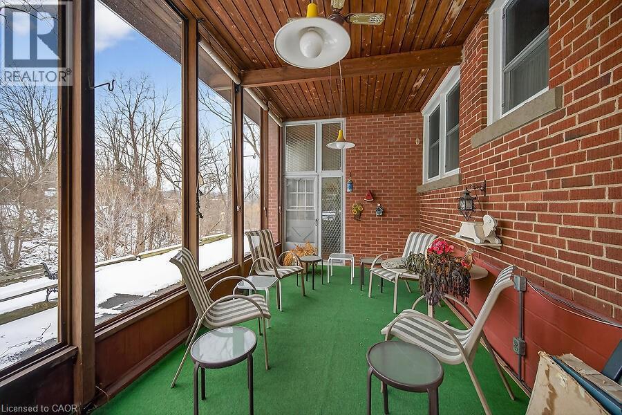 Sunroom / solarium with wood ceiling and brick wall - 9 Daleview Court, Hamilton, ON - With Exterior