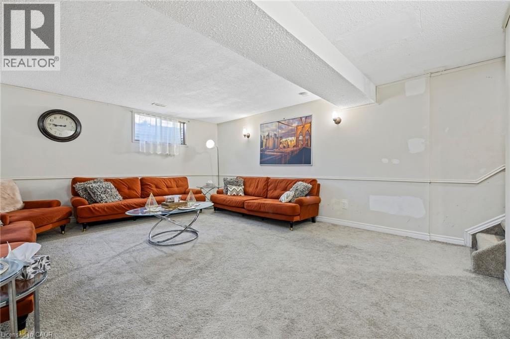 Carpeted living area with a textured ceiling and baseboards - 490 Queen Victoria Drive, Hamilton, ON - Indoor Photo Showing Living Room
