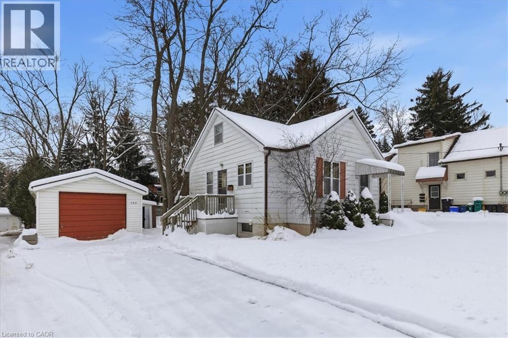 Snow covered property with an outdoor structure and a garage - 389 Erb Street W, Waterloo, ON - Outdoor