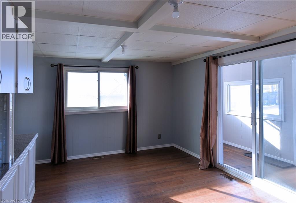 Unfurnished room featuring beam ceiling and dark wood-style floors - 1448 Upper Ottawa Street, Hamilton, ON - Indoor Photo Showing Other Room