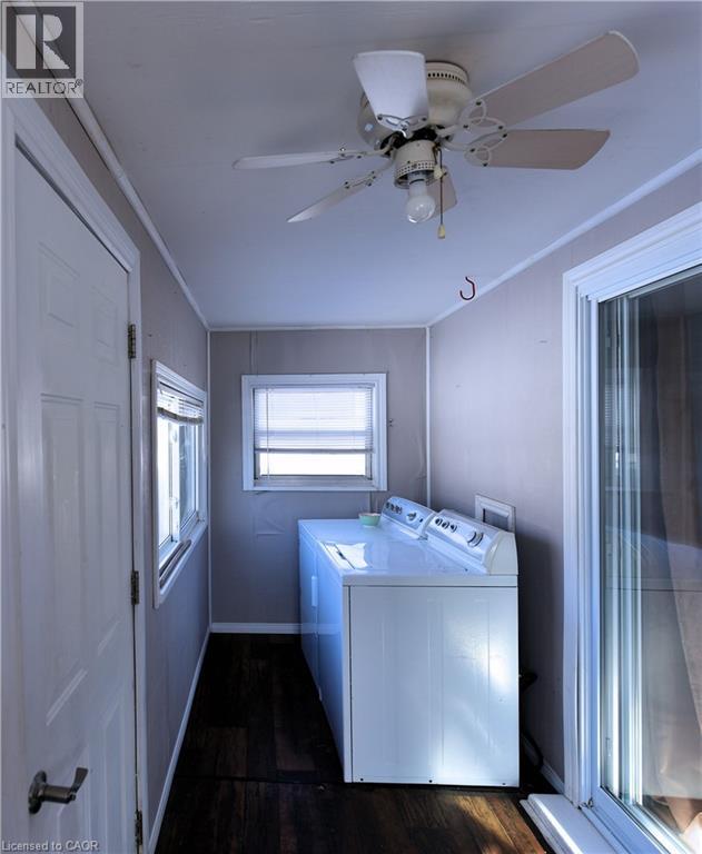 Laundry room featuring washing machine and clothes dryer, dark wood-style flooring, and ceiling fan - 1448 Upper Ottawa Street, Hamilton, ON - Indoor Photo Showing Laundry Room