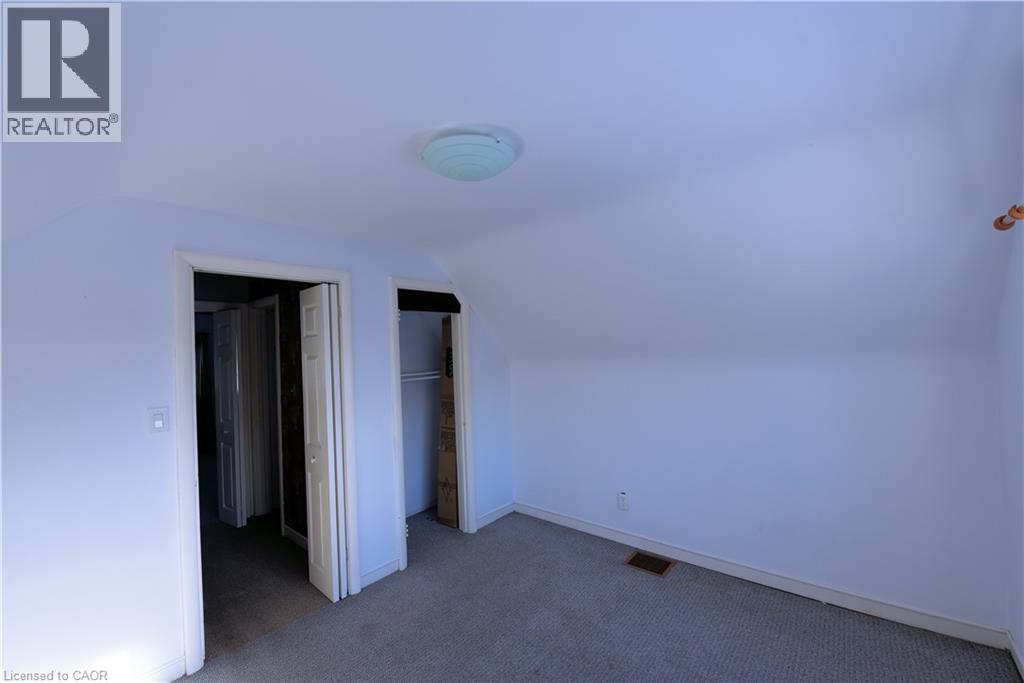 Additional living space featuring dark carpet and vaulted ceiling - 1448 Upper Ottawa Street, Hamilton, ON - Indoor