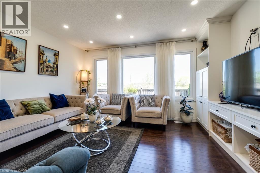 Living room featuring a textured ceiling, recessed lighting, and dark wood-type flooring - 928 Dunblane Court, Kitchener, ON - Indoor Photo Showing Living Room