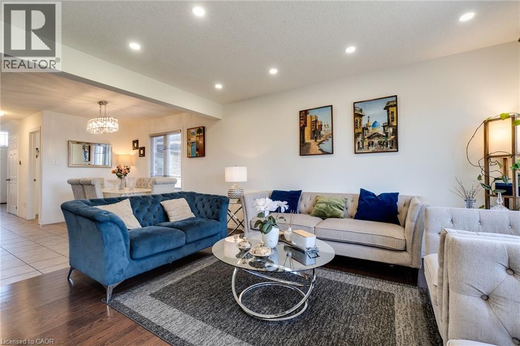 Living room with recessed lighting, a chandelier, a textured ceiling, and wood finished floors - 928 Dunblane Court, Kitchener, ON - Indoor Photo Showing Living Room