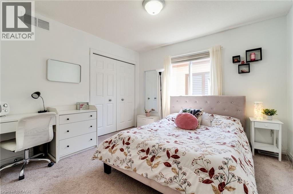 Bedroom featuring light carpet, a closet, and an office area - 928 Dunblane Court, Kitchener, ON - Indoor Photo Showing Bedroom