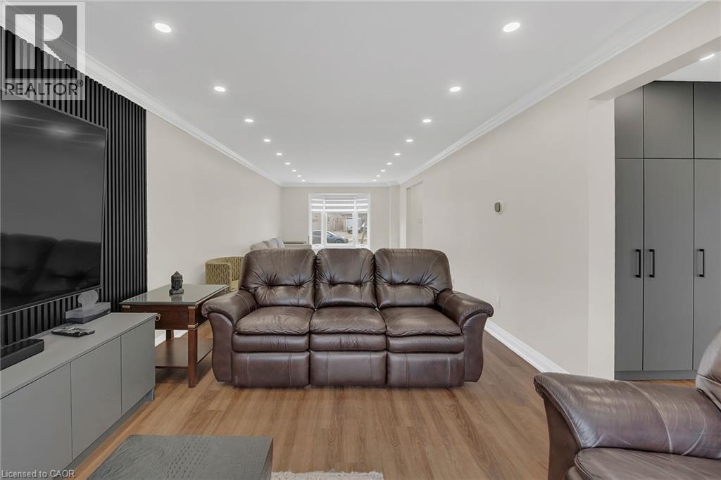 Living room with ornamental molding, light wood-type flooring, and recessed lighting - 125 Valera Drive, Hamilton, ON - Indoor Photo Showing Living Room