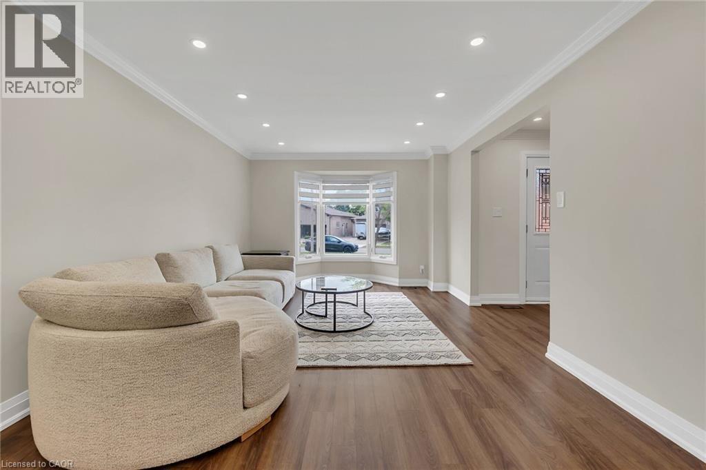 Living room featuring crown molding, recessed lighting, and wood finished floors - 125 Valera Drive, Hamilton, ON - Indoor Photo Showing Living Room