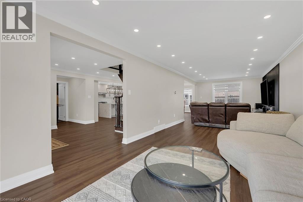 Living room featuring dark wood-style flooring, recessed lighting, and crown molding - 125 Valera Drive, Hamilton, ON - Indoor Photo Showing Living Room