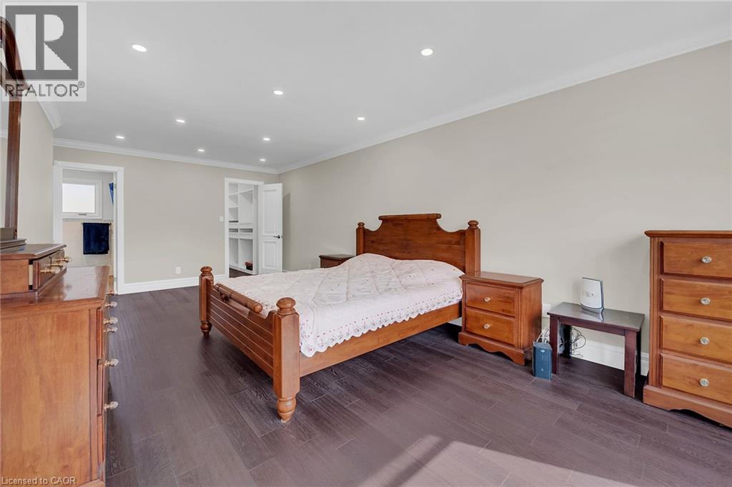 Bedroom with recessed lighting, crown molding, a walk in closet, and dark wood finished floors - 125 Valera Drive, Hamilton, ON - Indoor Photo Showing Bedroom