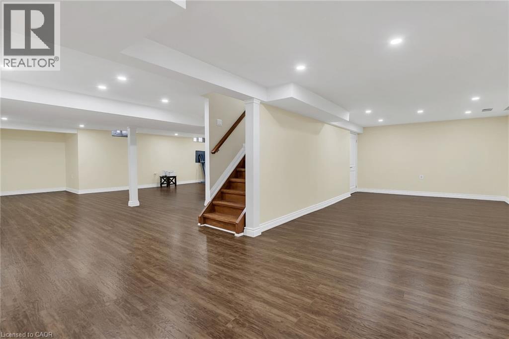 Finished basement featuring recessed lighting, dark wood finished floors, and stairs - 125 Valera Drive, Hamilton, ON - Indoor