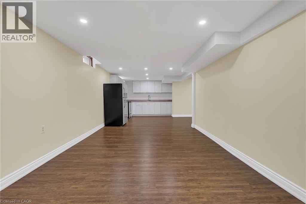 Unfurnished living room featuring dark wood-type flooring and recessed lighting - 125 Valera Drive, Hamilton, ON - Indoor Photo Showing Other Room