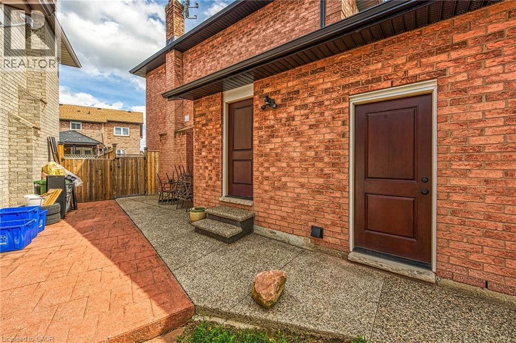 Doorway to property with a patio, brick siding, and a chimney - 125 Valera Drive, Hamilton, ON - Outdoor With Exterior