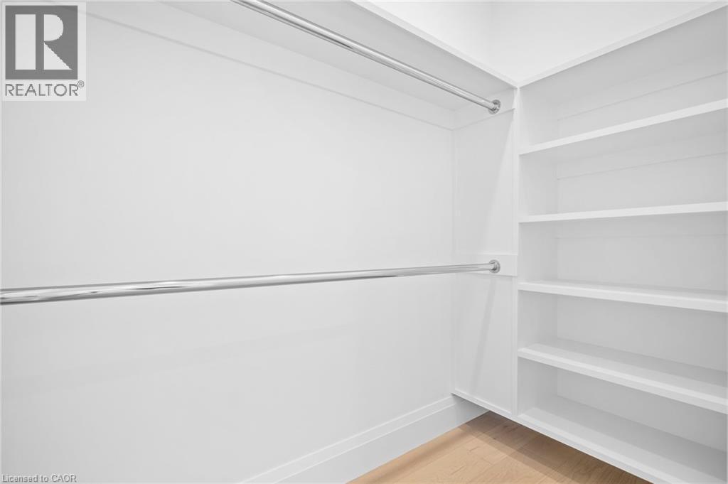 Walk in closet with light wood-style flooring - 1322 Minaki Road, Mississauga, ON - Indoor Photo Showing Other Room