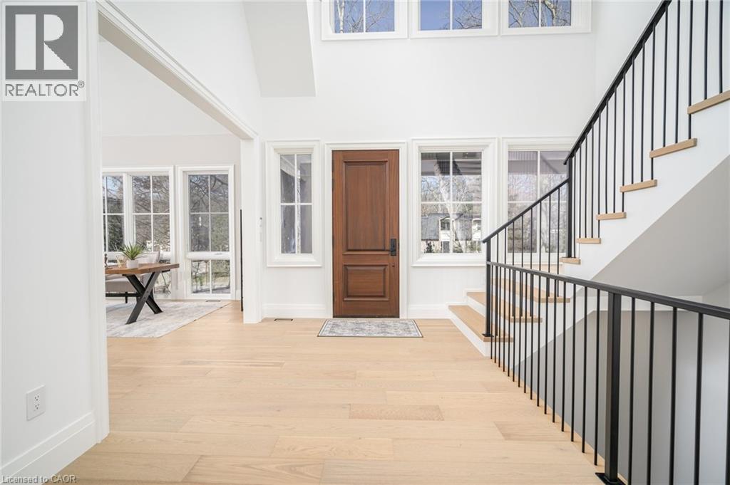 Foyer with a high ceiling, light wood finished floors, and stairs - 1322 Minaki Road, Mississauga, ON - Indoor Photo Showing Other Room