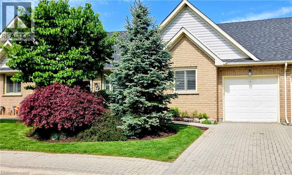 Exterior featuring light brick siding with white gables and a dark shingle roof - 165 Main Street E Unit# 9, Grimsby, ON - Outdoor