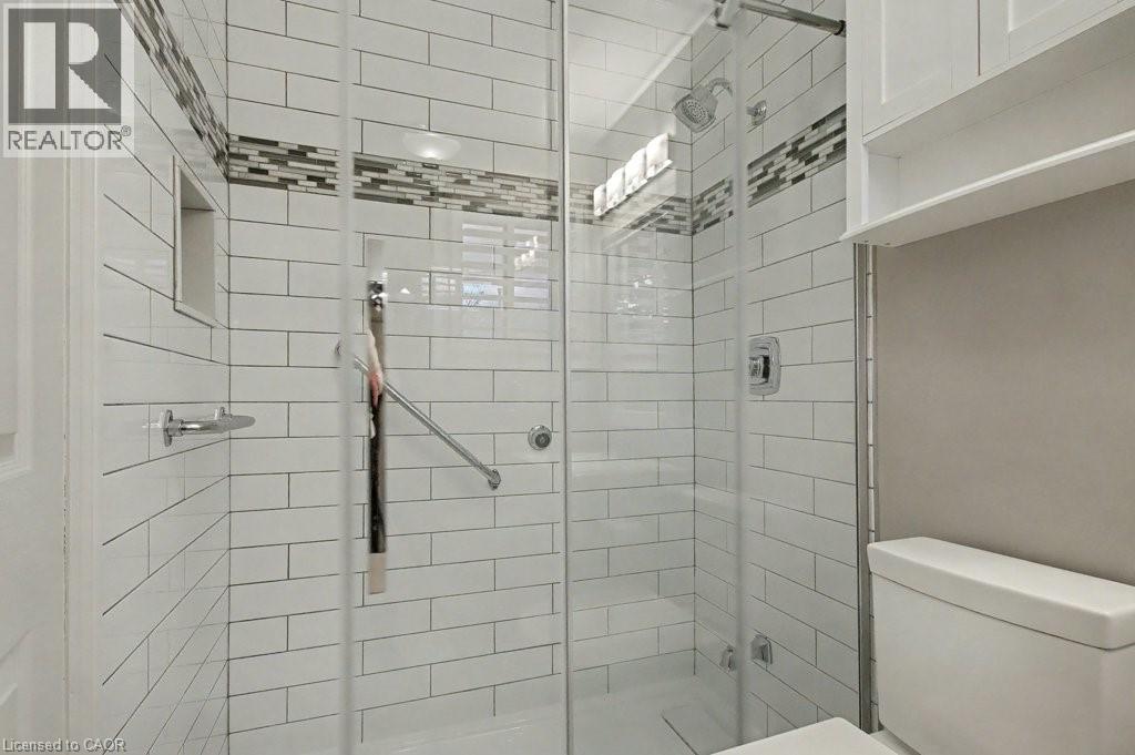 Full bathroom featuring a stall shower and toilet - 165 Main Street E Unit# 9, Grimsby, ON - Indoor Photo Showing Bathroom