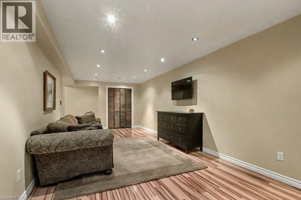 Living area featuring light wood finished floors and recessed lighting - 165 Main Street E Unit# 9, Grimsby, ON - Indoor