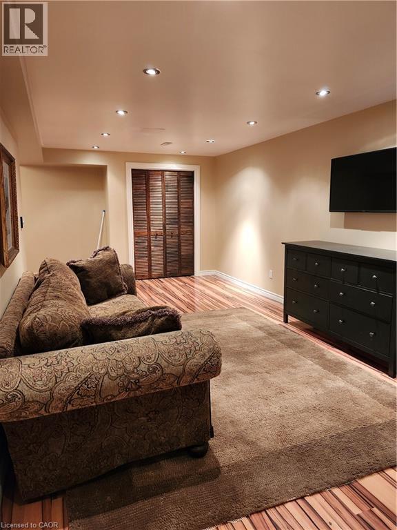 Living room featuring light wood-style floors and recessed lighting - 165 Main Street E Unit# 9, Grimsby, ON - Indoor Photo Showing Bedroom
