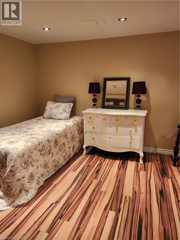 Bedroom featuring wood finished floors and recessed lighting - 165 Main Street E Unit# 9, Grimsby, ON - Indoor Photo Showing Bedroom
