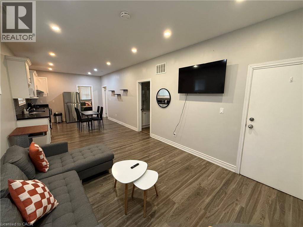 Living area with dark wood-type flooring and recessed lighting - 106 Spadina Avenue Unit# 1, Hamilton, ON - Indoor
