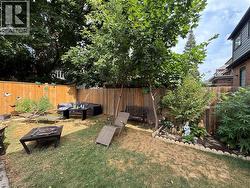 Fenced backyard with an outdoor fire pit -