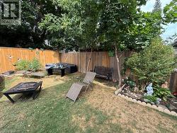 Fenced backyard with an outdoor hangout area -