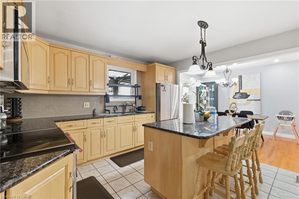 Kitchen with light brown cabinets, appliances with stainless steel finishes, and light tile patterned floors - 364 Roselawn Place, Waterloo, ON - Indoor Photo Showing Kitchen