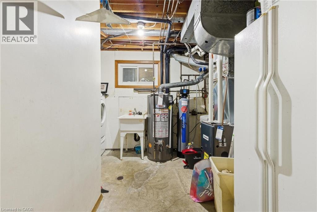 Unfinished below grade area featuring gas water heater and a water softener system - 364 Roselawn Place, Waterloo, ON - Indoor Photo Showing Basement