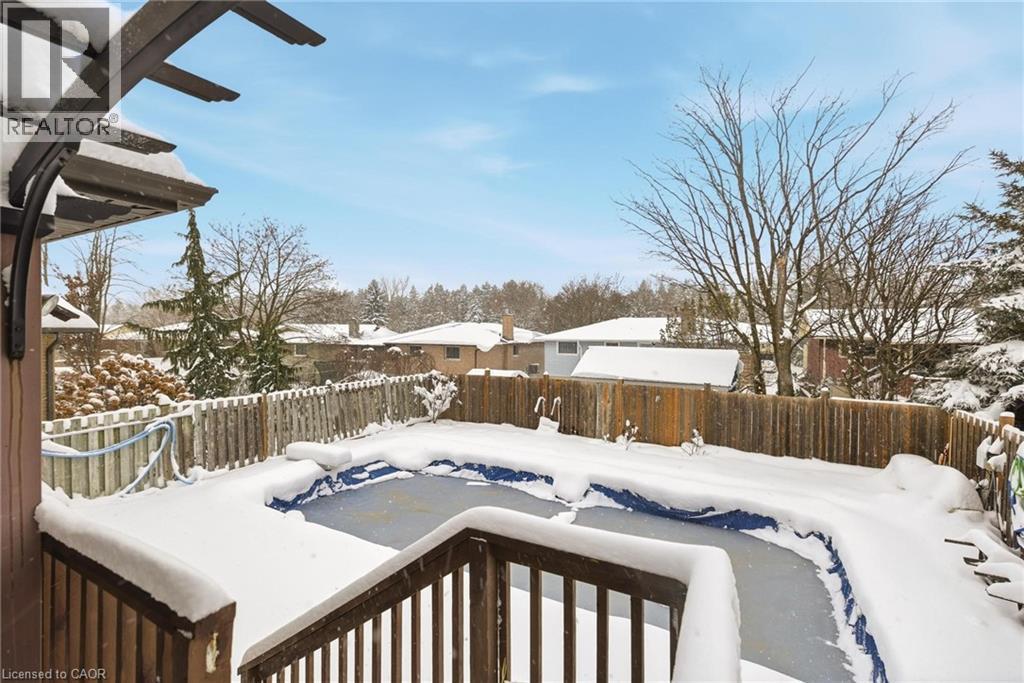 Yard covered in snow with a fenced backyard, a wooden deck, and a residential view - 364 Roselawn Place, Waterloo, ON - Outdoor