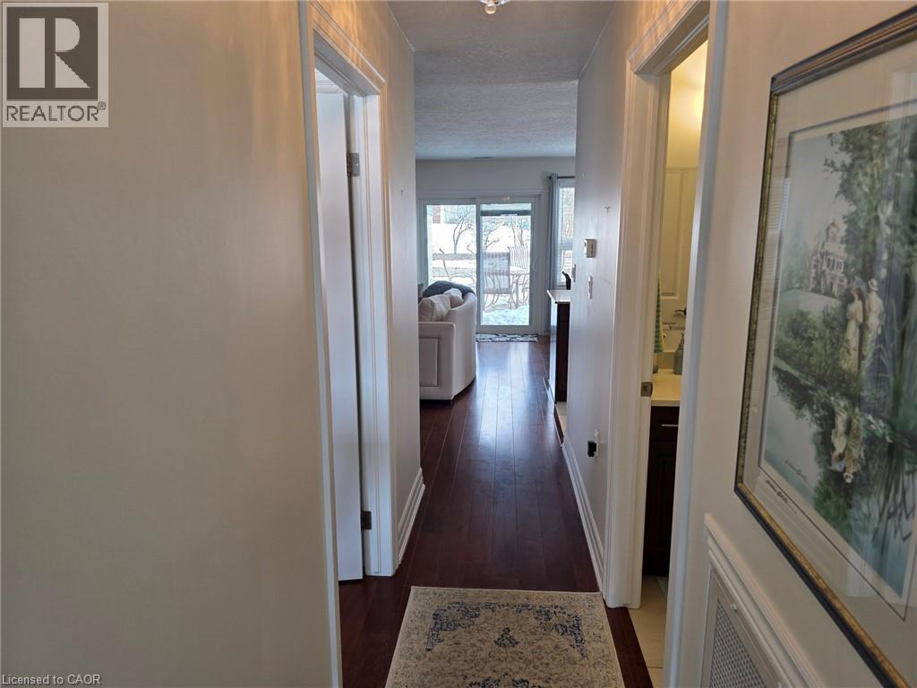 Hallway featuring dark wood-type flooring and baseboards - 49 Bishop Reding Trail, Hamilton, ON - Indoor Photo Showing Other Room
