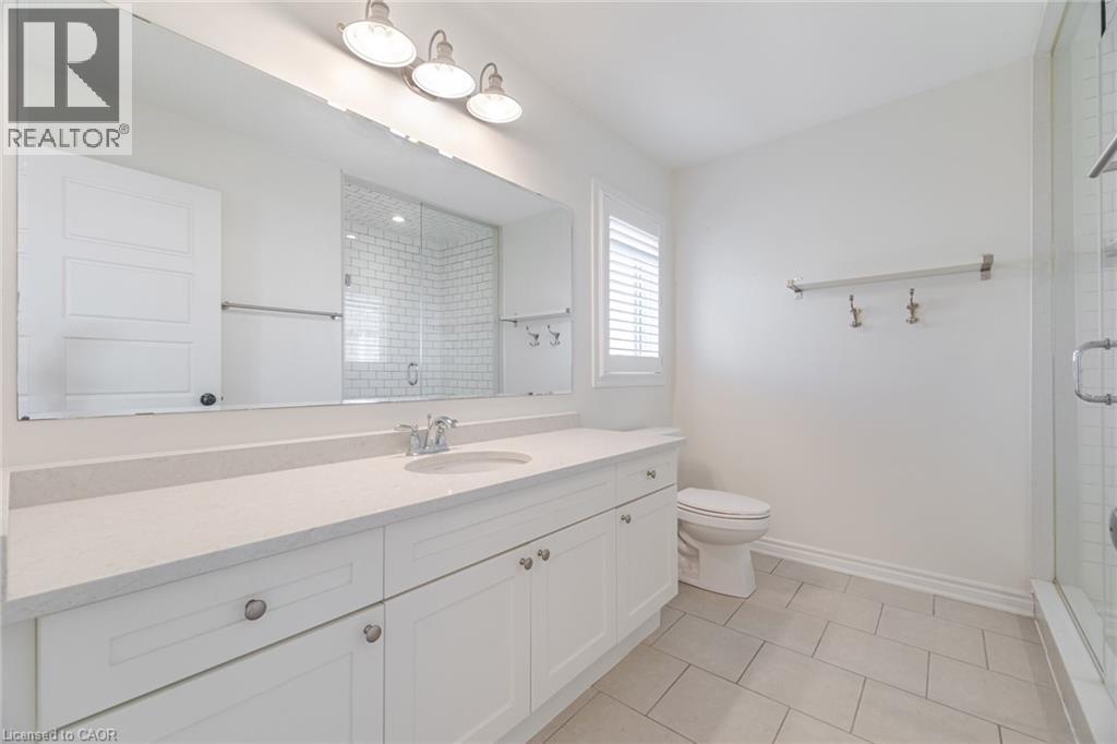 Full bathroom featuring vanity, light tile patterned floors, and a shower stall - 28 Pickett Place, Cambridge, ON - Indoor Photo Showing Bathroom
