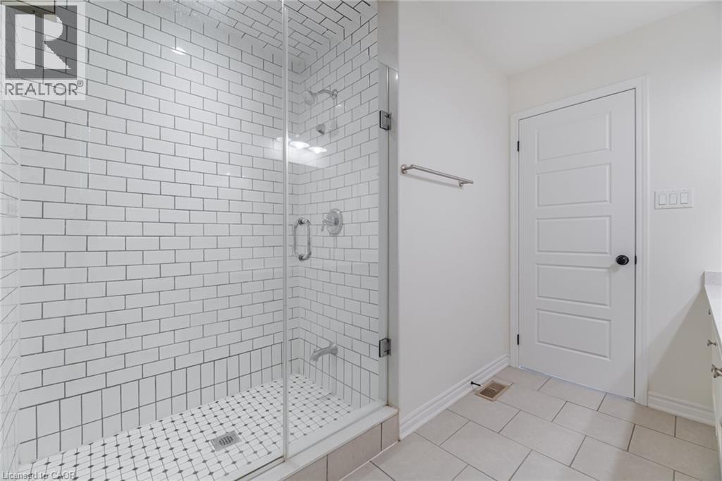 Full bath featuring vanity, light tile patterned flooring, and a stall shower - 28 Pickett Place, Cambridge, ON - Indoor Photo Showing Bathroom