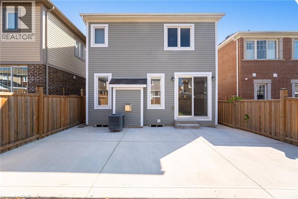Rear view of house with a patio area, a fenced backyard, and entry steps - 28 Pickett Place, Cambridge, ON - Outdoor