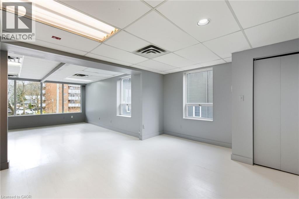 Spare room with a drop ceiling and light wood-style flooring - 17 King Street E Unit# 205, Dundas, ON