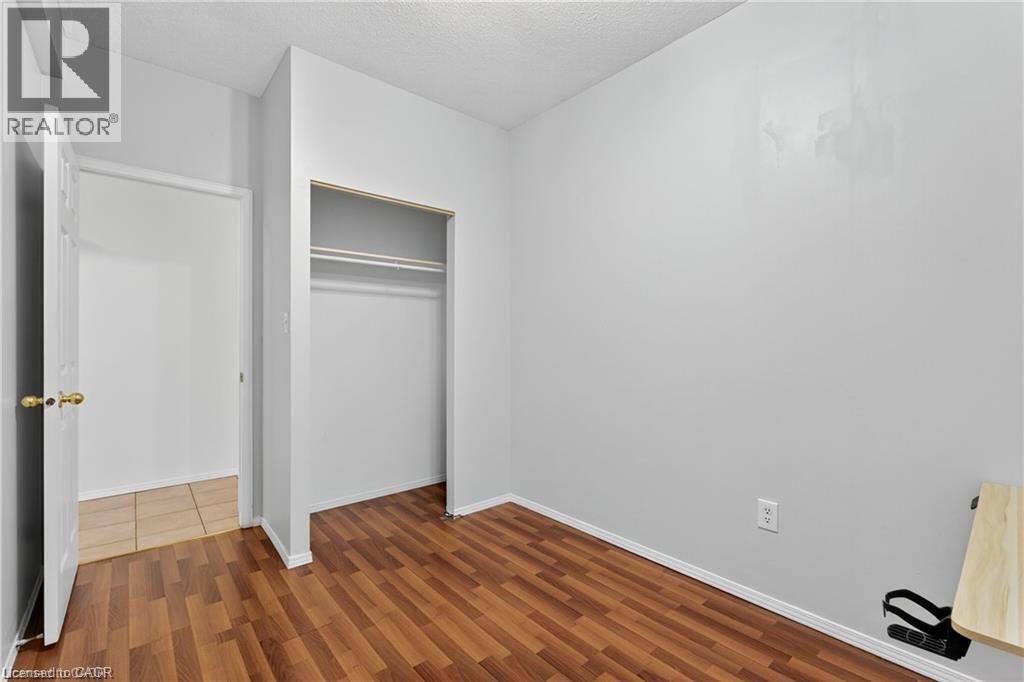 Unfurnished bedroom with wood-style flooring, a closet - 111 Hillyard Street, Hamilton, ON - Indoor Photo Showing Other Room