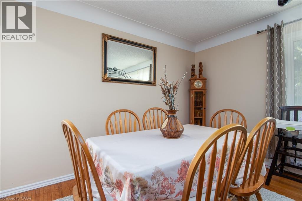 Dining space with wood finished floors and a textured ceiling - 129 River Road E, Kitchener, ON - Indoor Photo Showing Dining Room