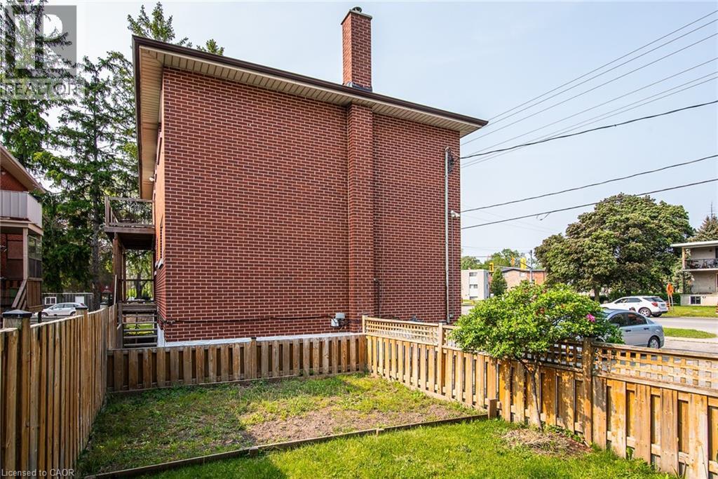 View of property exterior with brick siding and a chimney - 129 River Road E, Kitchener, ON - Outdoor With Exterior